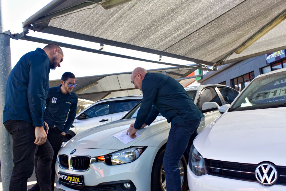 Automax Team Inspecting A Car
